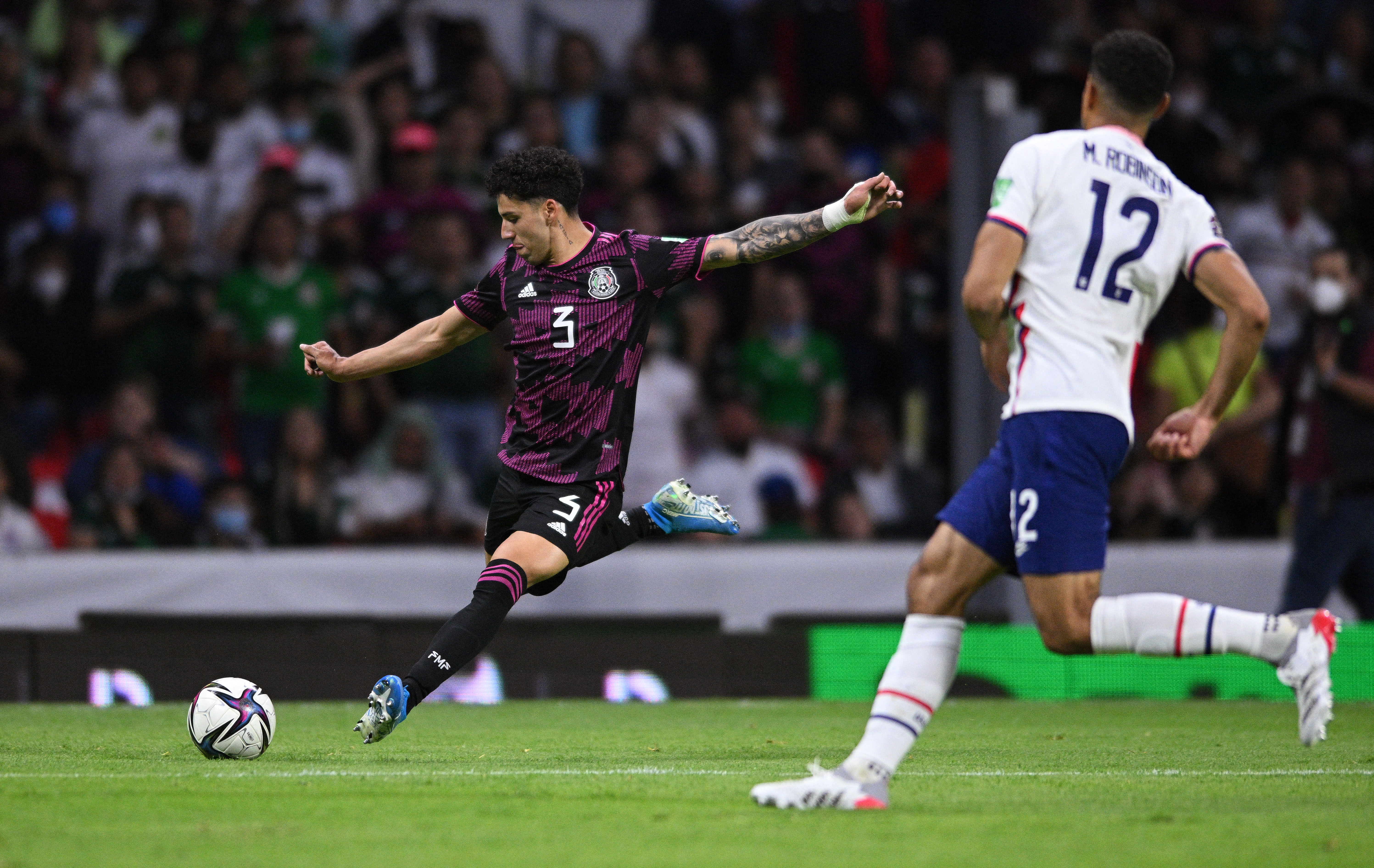 Mar 24, 2022; Mexico City, MEX; Mexico defender Jorge Sanchez (3) crosses a pass past United States defender Miles Robinson (12) during the first half during a FIFA World Cup Qualifier soccer match at Estadio Azteca. Mandatory Credit: Orlando Ramirez-USA TODAY Sports