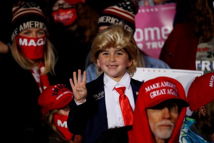 Un niño en la audiencia levanta cuatro dedos durante el mitin de campaña del presidente de los Estados Unidos, Donald Trump, en el Aeropuerto Internacional Erie en Erie, Pensilvania, Estados Unidos, [20 de octubre de 2020] (Reuters/ Tom Brenner) (TPX IMAGES OF THE DAY)