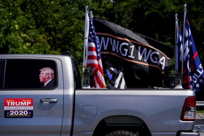 Pro-Trump flags and a flag reading WWG1WGA, a reference to the QAnon  slogan is seen on a truck that participated in a caravan convoy in Adairsville, Georgia, U.S. September 5, 2020.    REUTERS/Elijah Nouvelage