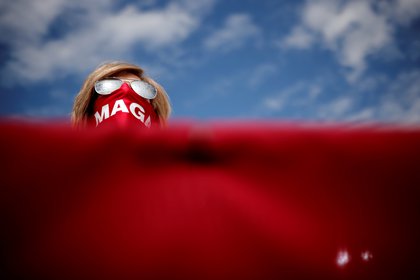 A supporter of U.S. President Donald Trump wears a MAGA (Make America Great Again) protective face mask during a campaign rally at Pitt-Greenville Airport in Greenville, North Carolina, U.S., October 15, 2020. REUTERS/Carlos Barria