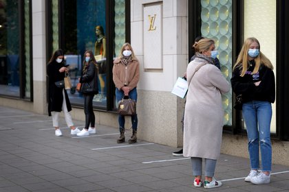 Personas en una cola de protección en el exterior de la tienda de Louis Vuitton en Frankfurt, Alemania, el 28 de octubre de 2020, REUTERS/Kai Pfaffenbach